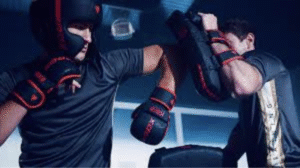 Amateur boxer adjusting boxing gloves before practice session