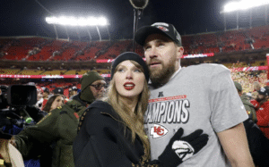 Taylor Swift showing engagement ring with a smile